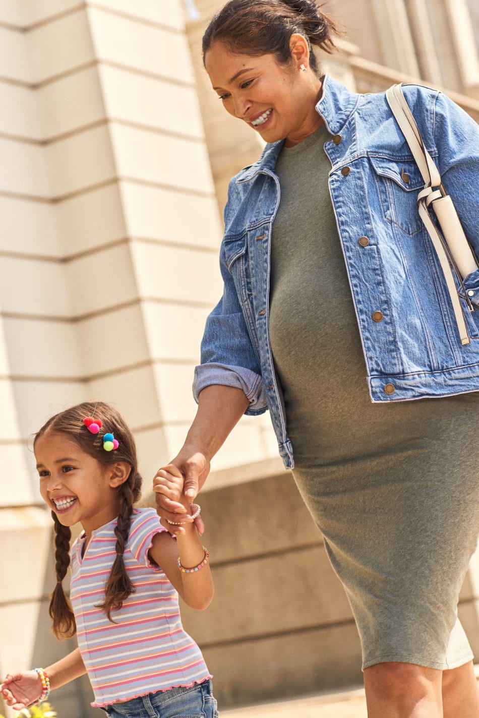 Pregnant model wearing Stitch Fix maternity clothing including jean jacket and green dress; kid’s model wearing striped shirt.