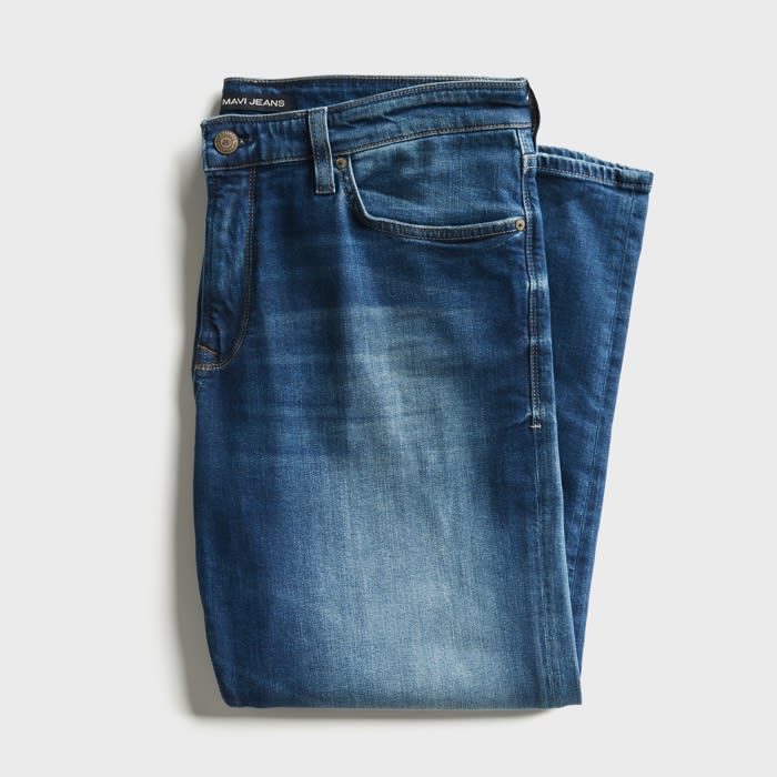 Distressed medium wash relaxed fit blue jeans.