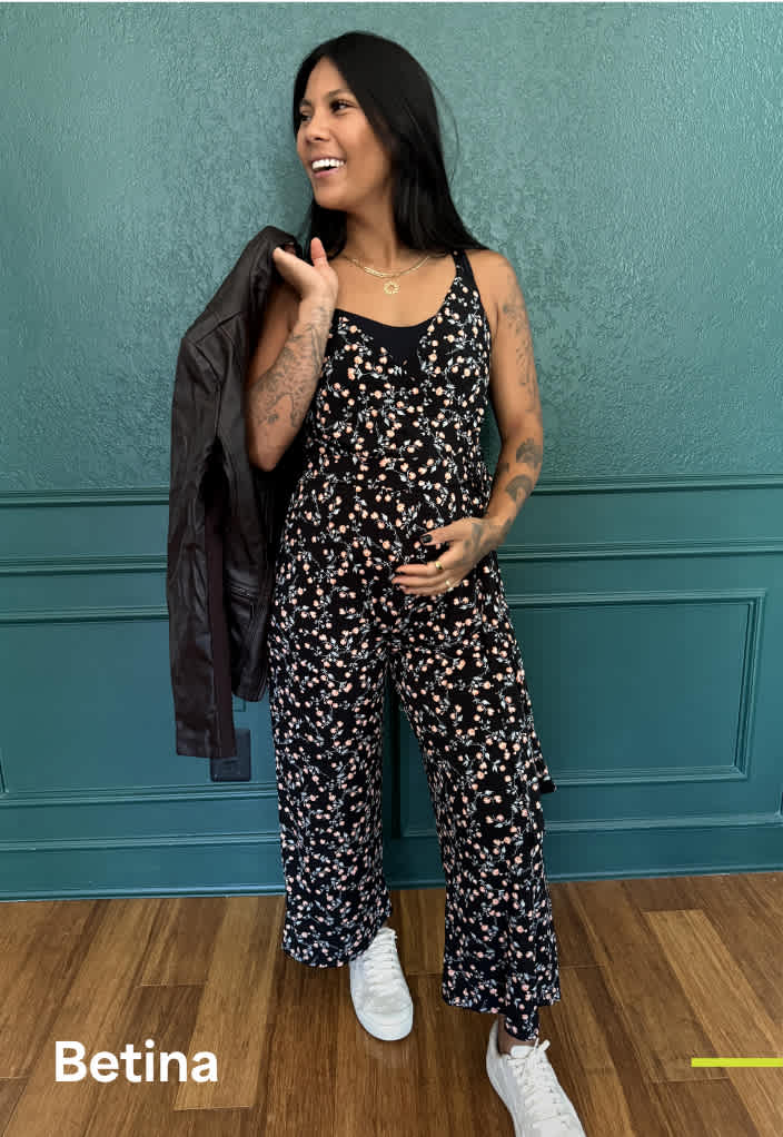 Woman wearing Stitch Fix clothing including patterned jumpsuit and white sneakers.