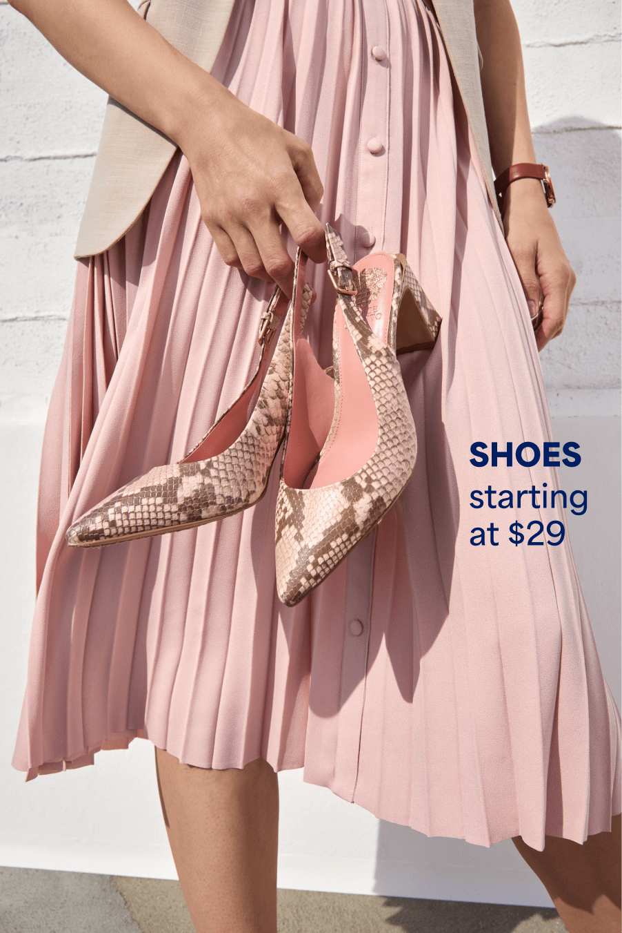 Model wearing Stitch Fix women’s clothes including beige blazer, pink midi skirt and snake print heels. Text reads: SHOES starting at $28.