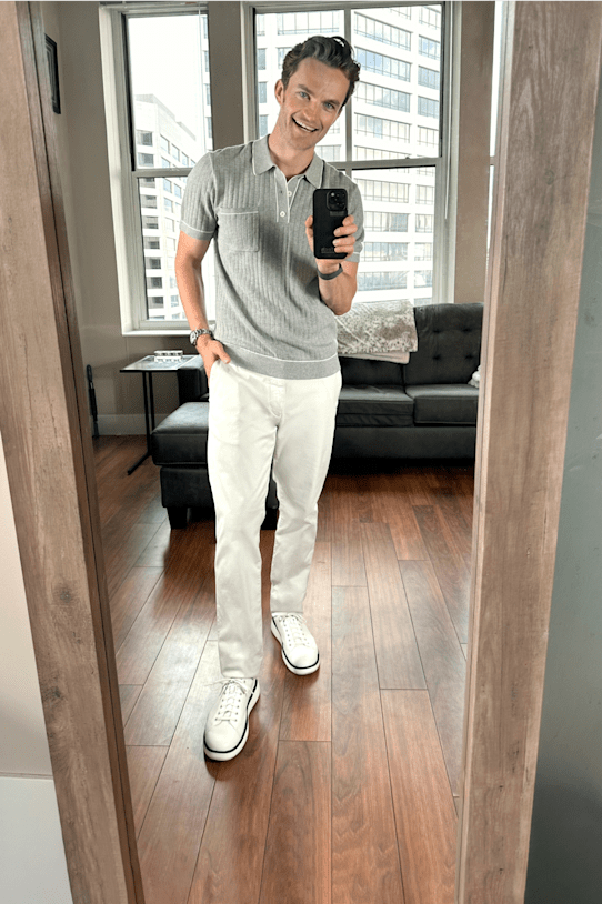 Model wearing Stitch Fix mens clothing: gray collared shirt, white pants and white sneakers.